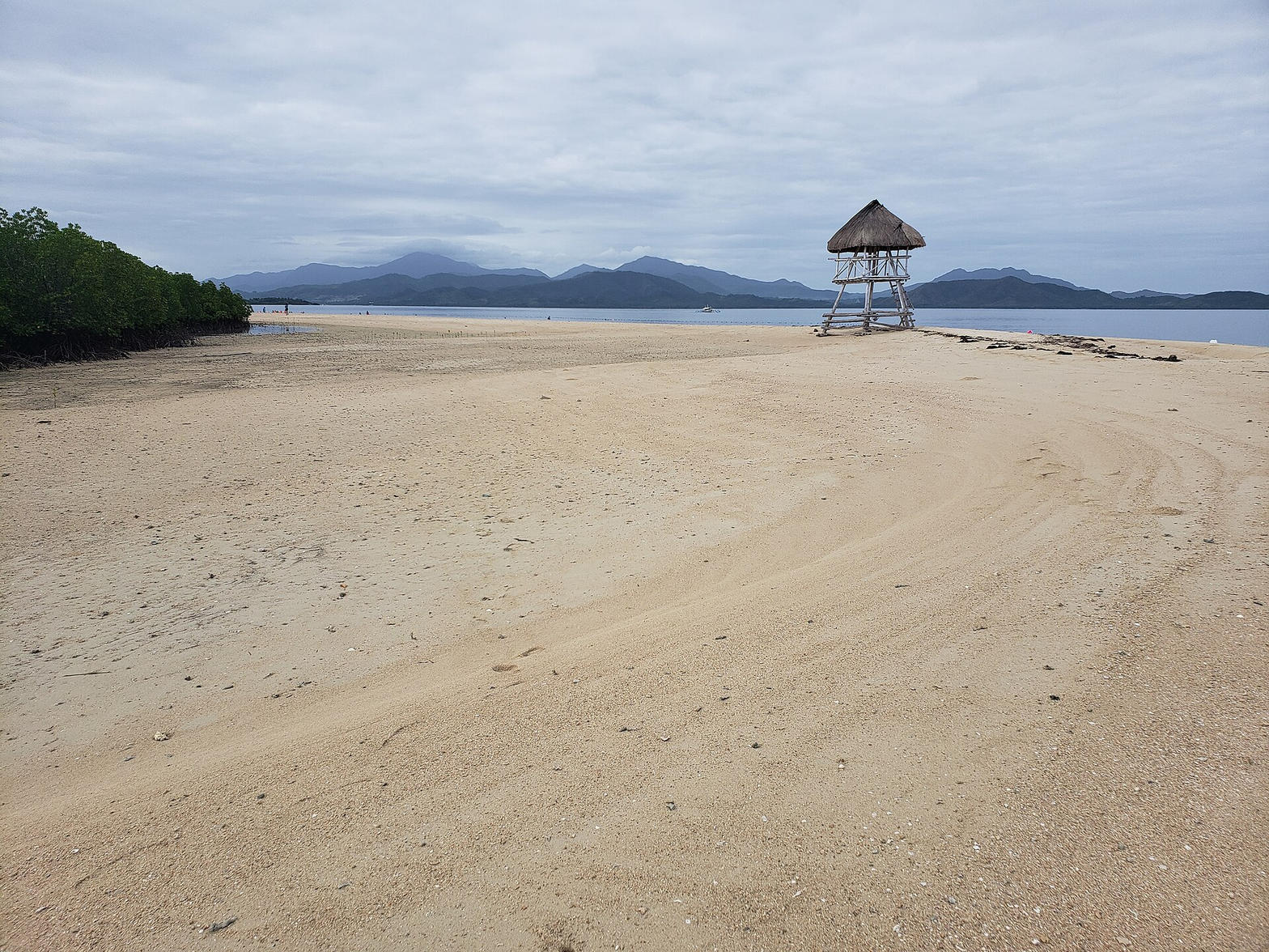Wide sandbar and a nipa hut on Honda Bay